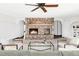 Inviting living room featuring a stone fireplace, arched entryways, and neutral decor for a cozy atmosphere at 10690 County Road One, Longmont, CO 80504