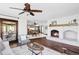 Open living space with a white brick fireplace and views of the dining and kitchen areas at 10690 County Road One, Longmont, CO 80504