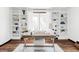 Bright and spacious home office featuring built-in bookshelves and a comfortable workspace at 10690 County Road One, Longmont, CO 80504