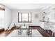 Bright playroom features bay windows, play tent, table, and built-in desk and cabinets at 10690 County Road One, Longmont, CO 80504