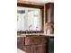 Close up of copper farmhouse sink with wood cabinets and a window providing natural light at 10690 County Road One, Longmont, CO 80504