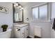 Bathroom featuring neutral walls, modern vanity and mirror, and ample lighting complemented by decor and natural light at 3378 Mowry Pl, Westminster, CO 80031