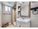 Tiled bathroom with a modern vanity, shower, and bright natural light at 3378 Mowry Pl, Westminster, CO 80031