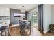 Dining area with hardwood floors, modern lighting, and sliding glass doors to the outside at 3378 Mowry Pl, Westminster, CO 80031