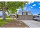 Inviting exterior view of home with a well-manicured lawn, mature tree, and a two-car garage at 3378 Mowry Pl, Westminster, CO 80031