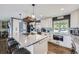 Spacious kitchen with a large island, white cabinets, and stainless steel appliances at 3378 Mowry Pl, Westminster, CO 80031
