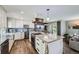 Bright and airy kitchen with a large island, sleek countertops, and modern finishes at 3378 Mowry Pl, Westminster, CO 80031