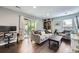 Bright living room featuring hardwood floors, light gray walls, and a sliding glass door that opens to the backyard at 3378 Mowry Pl, Westminster, CO 80031