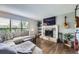 Cozy living room with a stone fireplace, plush seating, and large window at 3378 Mowry Pl, Westminster, CO 80031