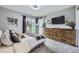 Cozy main bedroom boasts great natural light, gray walls, plush carpet, and deck access through sliding glass doors at 3378 Mowry Pl, Westminster, CO 80031