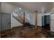 Spacious basement with exposed support beams, modern lighting, and convenient laundry setup at 1260 Hudson St, Denver, CO 80220