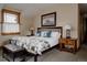 Comfortable bedroom showcases a beautifully decorated bed, bench and a large window with natural light at 1260 Hudson St, Denver, CO 80220