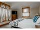 Bedroom features a decorated bed, window with natural light, dresser with TV and beautiful decor at 1260 Hudson St, Denver, CO 80220