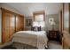 Cozy bedroom with a comfortable bed, wood trim and ample natural light offers a peaceful retreat at 1260 Hudson St, Denver, CO 80220