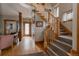 Open entryway featuring hardwood floors, a staircase, and decorative wooden trim at 1260 Hudson St, Denver, CO 80220