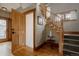 Welcoming entryway with a wooden staircase, hardwood floors, and a stylish interior door at 1260 Hudson St, Denver, CO 80220