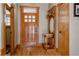 Inviting foyer with hardwood floors, a wooden front door, and a decorative hall tree at 1260 Hudson St, Denver, CO 80220