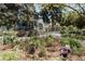 Beautifully landscaped front yard with lush garden beds, flowers, and a glimpse of the charming home at 1260 Hudson St, Denver, CO 80220
