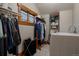 Efficient laundry room with built-in shelving, convenient storage, and natural light from a window at 1260 Hudson St, Denver, CO 80220