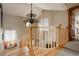 Staircase landing featuring wood banister and trim, a decorative light fixture and a charming window seat at 1260 Hudson St, Denver, CO 80220