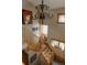Staircase features an ornate chandelier, artistic decor and a cozy window seat filled with colorful pillows at 1260 Hudson St, Denver, CO 80220