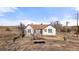 Exterior of home surrounded by dry grass and weeds at 14624 County Road 12, Fort Lupton, CO 80621
