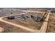 A wide, exterior angle shows a expansive, dirt lot with several buildings at 14624 County Road 12, Fort Lupton, CO 80621