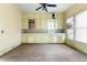 A view of the kitchen with old wood cabinets and dated appliances at 14624 County Road 12, Fort Lupton, CO 80621