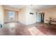 A view of the living room showing the hardwood floors and dated walls and ceiling at 14624 County Road 12, Fort Lupton, CO 80621