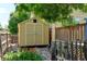 Backyard featuring a storage shed, garden with flowers, and a charming wooden fence at 5241 E 128Th Way, Thornton, CO 80241
