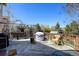 Spacious wooden deck with a covered grill area, furniture, and treed view at 5241 E 128Th Way, Thornton, CO 80241