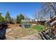 Backyard featuring a greenhouse, garden area, and lush green grass at 5241 E 128Th Way, Thornton, CO 80241