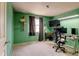 Bedroom with green walls and a functional workspace with a modern desk setup at 5241 E 128Th Way, Thornton, CO 80241