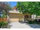 Charming two-story home boasts a well-manicured lawn, mature trees, and welcoming curb appeal at 5241 E 128Th Way, Thornton, CO 80241