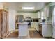 Bright kitchen features stainless steel appliances, tile floors and white cabinets at 5241 E 128Th Way, Thornton, CO 80241