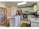 Bright kitchen features stainless steel appliances, tile floors and white cabinets at 5241 E 128Th Way, Thornton, CO 80241