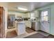 Bright kitchen features stainless steel appliances, tile floors and white cabinets at 5241 E 128Th Way, Thornton, CO 80241
