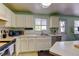 Bright kitchen features stainless steel appliances, tile floors and white cabinets at 5241 E 128Th Way, Thornton, CO 80241
