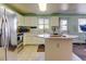 Functional kitchen with ample cabinet space, stainless steel appliances, and a convenient center island at 5241 E 128Th Way, Thornton, CO 80241