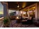 Relaxing covered back deck with plush seating, fire pit, ceiling fan and scenic views at 696 Eveningsong Dr, Castle Rock, CO 80104