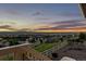 Backyard view of neighborhood with fenced yard and scenic sunset at 696 Eveningsong Dr, Castle Rock, CO 80104