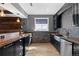 Finished basement bar with wood cabinets, stone accents, stainless sink and open window at 696 Eveningsong Dr, Castle Rock, CO 80104
