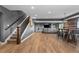 Open basement layout with wood floors, bar, entertainment area, and staircase at 696 Eveningsong Dr, Castle Rock, CO 80104