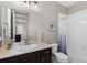 Bright bathroom with a shower-tub and a dark vanity with a large mirror at 696 Eveningsong Dr, Castle Rock, CO 80104