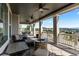 Relaxing covered deck featuring a stone fire pit and comfortable seating at 696 Eveningsong Dr, Castle Rock, CO 80104