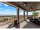 Spacious covered deck with ceiling fans, seating, and mountain views at 696 Eveningsong Dr, Castle Rock, CO 80104