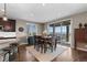 Cozy dining room area featuring a wooden table, stylish chairs, and a sliding glass door to the outdoor patio at 696 Eveningsong Dr, Castle Rock, CO 80104