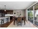 Bright dining area with hardwood floors, a stylish table set, and sliding doors to a patio with stunning views at 696 Eveningsong Dr, Castle Rock, CO 80104