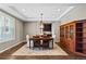 Elegant dining room with modern light fixture, cabinet and large window at 696 Eveningsong Dr, Castle Rock, CO 80104