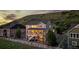 Charming two-story home boasts a wrap-around porch, backyard, and scenic sunset views at 696 Eveningsong Dr, Castle Rock, CO 80104